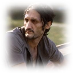 A softly vignetted portrait of a dark-haired man looking sideways